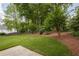 Expansive backyard with well-maintained lawn, mature trees, and mulch beds, perfect for outdoor activities and relaxation at 427 Picketts Lake Dr, Acworth, GA 30101