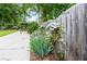 Scenic backyard featuring a stone pathway and a gazebo, enhanced by flowering plants and a weathered wooden fence at 427 Picketts Lake Dr, Acworth, GA 30101