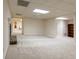 Expansive basement with multiple rooms, fireplace, and neutral carpet throughout at 427 Picketts Lake Dr, Acworth, GA 30101