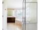 Well-lit bathroom with a glass enclosed shower and a large soaking tub at 427 Picketts Lake Dr, Acworth, GA 30101