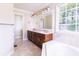 Bathroom has a double vanity, a large mirror, and a soaking tub at 427 Picketts Lake Dr, Acworth, GA 30101