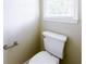 Bathroom featuring a white toilet next to a window at 427 Picketts Lake Dr, Acworth, GA 30101