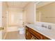 Well-lit bathroom with a combination tub and shower, tiled floors, and wood vanity at 427 Picketts Lake Dr, Acworth, GA 30101