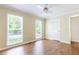 Well-lit bedroom with hardwood floors, neutral tones, and a ceiling fan at 427 Picketts Lake Dr, Acworth, GA 30101