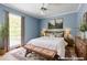 Cozy bedroom with a large window, soft blue walls, and decorative rug at 427 Picketts Lake Dr, Acworth, GA 30101