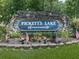 Elegant stone community sign for Pickett's Lake, decorated with American flags and colorful flowers at 427 Picketts Lake Dr, Acworth, GA 30101