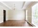 Bright dining room with hardwood floors, stylish chandelier, and lots of natural light from large windows at 427 Picketts Lake Dr, Acworth, GA 30101