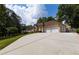 Wide driveway leading to a well-maintained home with a two-car garage and mature trees at 427 Picketts Lake Dr, Acworth, GA 30101