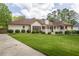 Charming one-story home with a well-manicured lawn, inviting porch, and attractive landscaping at 427 Picketts Lake Dr, Acworth, GA 30101