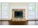 Living room with stone fireplace and bright natural light from adjacent windows at 427 Picketts Lake Dr, Acworth, GA 30101