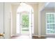 Bright and welcoming foyer featuring a glass-paneled door and hardwood floors at 427 Picketts Lake Dr, Acworth, GA 30101