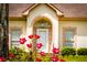 Close-up of the front entrance, framed by vibrant flowers and lush greenery at 427 Picketts Lake Dr, Acworth, GA 30101
