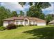 Charming one-story home with a well-manicured lawn and a two-car garage nestled among mature trees at 427 Picketts Lake Dr, Acworth, GA 30101