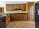 Spacious kitchen features custom cabinets, granite countertops, stainless appliances, and tile backsplash at 427 Picketts Lake Dr, Acworth, GA 30101