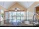 Eat-in kitchen with vaulted ceilings and stainless sink overlooking the backyard through a large window at 427 Picketts Lake Dr, Acworth, GA 30101