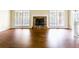 Cozy living room with hardwood floors, stone fireplace, and plenty of natural light from large windows at 427 Picketts Lake Dr, Acworth, GA 30101