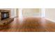 Large living room with hardwood floors, stone fireplace, and staircase to the second floor at 427 Picketts Lake Dr, Acworth, GA 30101
