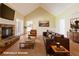 Virtually staged living room with vaulted ceiling, stone fireplace, plush sofa, and stylish decor at 427 Picketts Lake Dr, Acworth, GA 30101