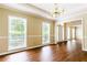 Inviting living room features gleaming hardwood floors, neutral paint, and abundant natural light from large windows at 427 Picketts Lake Dr, Acworth, GA 30101
