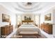 Staged main bedroom features a trey ceiling, two windows, and two dressers at 427 Picketts Lake Dr, Acworth, GA 30101