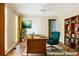 Home office with hardwood floors, a large desk, and ample bookshelf space. (Virtually Staged) at 427 Picketts Lake Dr, Acworth, GA 30101