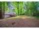 Lush backyard with mature trees providing shade and privacy at 5810 Tree Line Ter, Lithonia, GA 30058