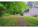 Side view of a backyard with mature trees at 5810 Tree Line Ter, Lithonia, GA 30058