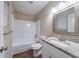 Well-lit bathroom featuring a granite countertop vanity, tub, and neutral decor at 5810 Tree Line Ter, Lithonia, GA 30058