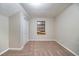 Bedroom with tan carpet, cream colored walls, and a window covered with plywood at 5810 Tree Line Ter, Lithonia, GA 30058