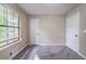 Bedroom with two doors, carpet, and a window with blinds for natural light and privacy at 5810 Tree Line Ter, Lithonia, GA 30058