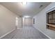 Bedroom with grey carpet, cream colored walls, and 3 entry doors at 5810 Tree Line Ter, Lithonia, GA 30058
