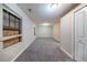 Bedroom with grey carpet, cream colored walls, and a window covered with plywood at 5810 Tree Line Ter, Lithonia, GA 30058
