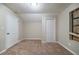Bedroom with tan carpet, cream colored walls, and two closets at 5810 Tree Line Ter, Lithonia, GA 30058