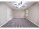 Cozy bedroom with neutral walls, plush carpet, and a ceiling fan at 5810 Tree Line Ter, Lithonia, GA 30058