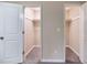 Dual walk-in closets provide ample storage with open doorways and neutral carpeting at 5810 Tree Line Ter, Lithonia, GA 30058
