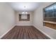 Dining room offers hardwood floors, modern chandelier, and window overlooking the street at 5810 Tree Line Ter, Lithonia, GA 30058