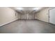View of the 2-car garage, featuring two overhead doors and concrete floor at 5810 Tree Line Ter, Lithonia, GA 30058
