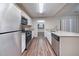 Updated kitchen with stainless steel appliances, granite countertops, and wood floors at 5810 Tree Line Ter, Lithonia, GA 30058