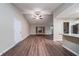 Spacious living room with wood floors, a ceiling fan, and natural light at 5810 Tree Line Ter, Lithonia, GA 30058