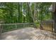 A spacious back deck with wooden railing and overlooking lush greenery, perfect for relaxing and entertaining at 9985 Lake Forest Way, Roswell, GA 30076