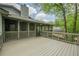 Upper-level back deck offering ample space for outdoor seating and dining, with views of mature trees at 9985 Lake Forest Way, Roswell, GA 30076