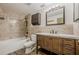 Full bathroom featuring custom tile work, a bathtub, and a wooden vanity at 9985 Lake Forest Way, Roswell, GA 30076