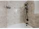 Elegant bathroom featuring neutral tilework and a modern black shower fixture at 9985 Lake Forest Way, Roswell, GA 30076