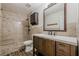 Beautiful bathroom with tiled shower, granite bench, and wooden vanity at 9985 Lake Forest Way, Roswell, GA 30076