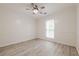 Bright bedroom with light wood flooring, ample natural light, and a ceiling fan at 9985 Lake Forest Way, Roswell, GA 30076