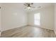 Bright bedroom featuring light wood flooring, a ceiling fan, and natural light at 9985 Lake Forest Way, Roswell, GA 30076