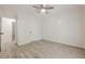 Spacious bedroom with light wood flooring and a glimpse into the hallway at 9985 Lake Forest Way, Roswell, GA 30076