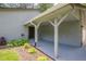 Home with covered carport and simple landscaping in the front yard at 9985 Lake Forest Way, Roswell, GA 30076
