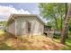 Exterior of home, back view, features wooden siding, a back deck, and lush greenery at 9985 Lake Forest Way, Roswell, GA 30076