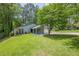 Charming single-story home featuring a well-manicured lawn and a cozy, covered entrance at 9985 Lake Forest Way, Roswell, GA 30076
